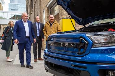 Ontario Energy Minister Todd Smith (second from left) walks toward a prototype electric vehicle created by a partnership between Litens and the University of Toronto’s Electric Vehicle Research Centre, led by Professor Olivier Trescases (ECE, second from right. Geoffrey Ryeland, Director, Electromotive Engineering at Litens is seen at right. (Photo: Aaron Demeter)