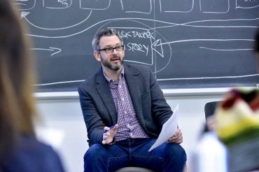 Andrew Westoll sits in the classroom