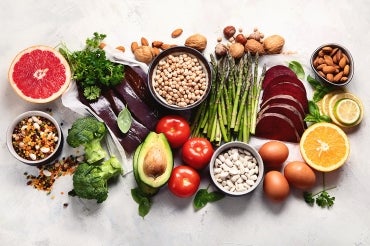 collection of foods high in folic acid including grapefruit, liver, avocado, asparagus, broccoli and nuts