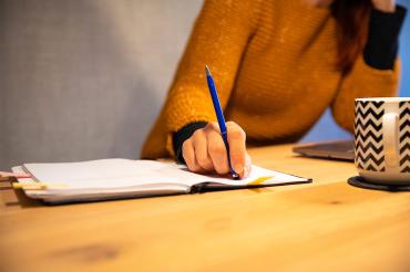 young adult woman looks stressed while studying