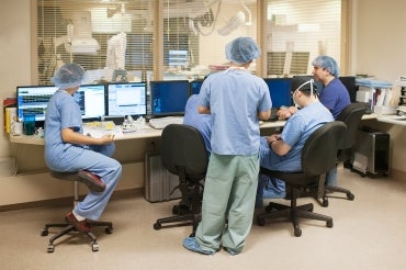 medical staff gather outside of an operating room