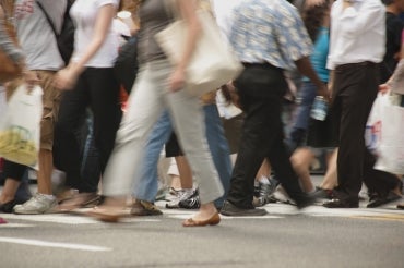 a crowd of anonymous people crossing the street