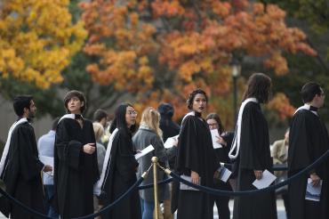 Photo of grads and fall trees