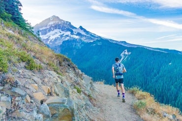 Photo of jogger on a mountain path