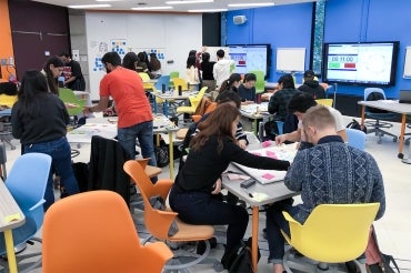 Students working in colourful Room 224 at the Bissell Building