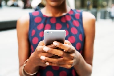 Woman holds a cellphone