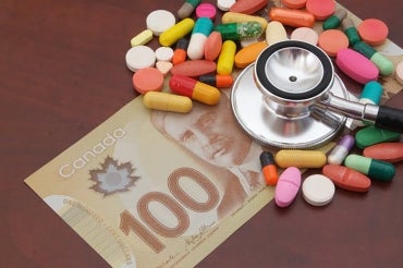 Photo illustration that includes pharmaceuticals, money and a physician's stethoscope