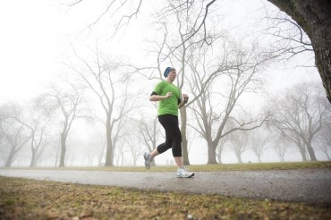 Woman jogging on a foggy morning