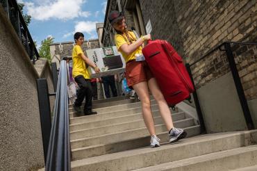 Photo of students bring their things to their dorms