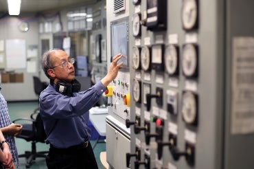 Boon Teak Lee, U of T's former chief engineer at the university's central steam plant, explains its operations on a student tour. Steam is delivered to many buildings across campus for heating spaces and making hot water.