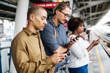 photo of commuters looking at their smartphones