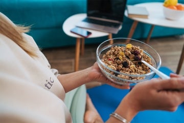 woman eating a bowl of granola