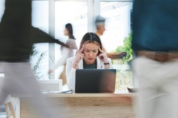 stressed out woman workingo on a laptop