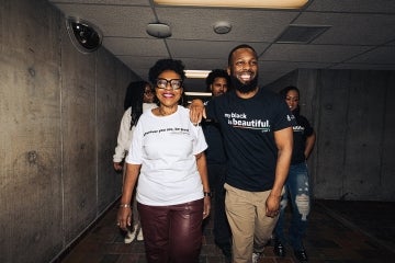 people walking down a utsc hallway dressed in the My Black is Beautiful apparel 