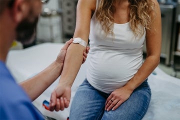 Pregnant woman recieves a blood test at a doctor's office