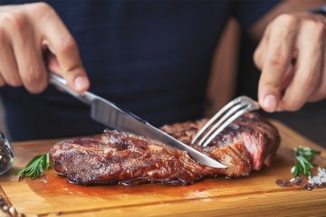 man eating a steak