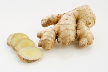 A photo of sliced ginger and ginger root