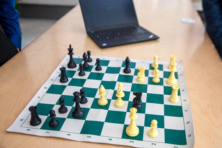 A chess board with a laptop