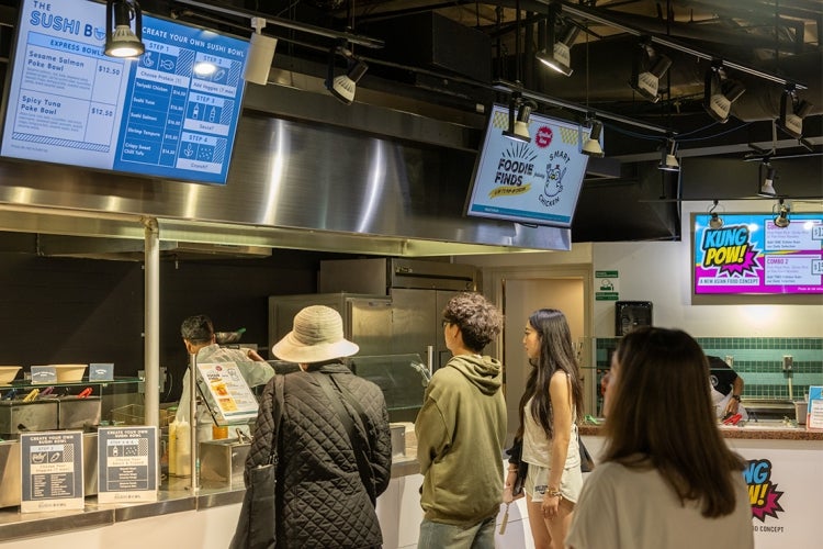 people in line examining the food options at Robarts dining hall