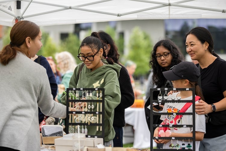 people browse the goods on sale by various Indigenous vendors