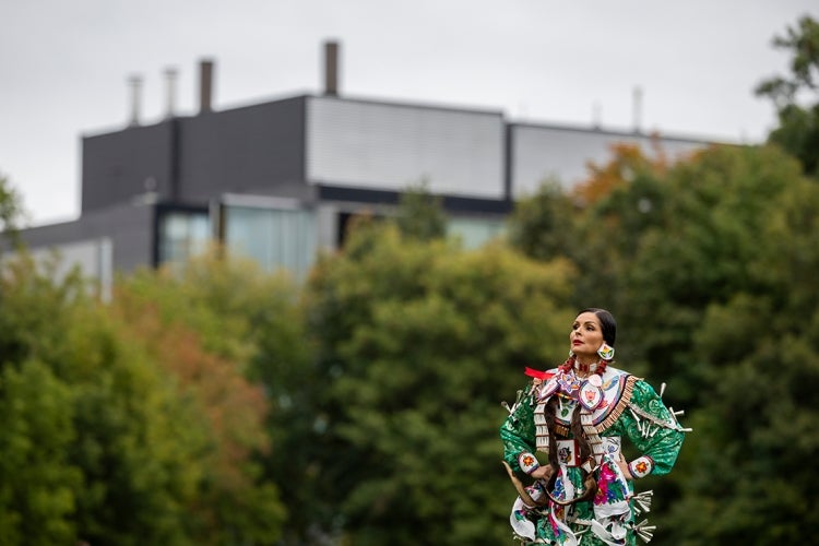 Portrait of Celeste Pedri-Spade in traditional dress for the Jingle Dress Dance